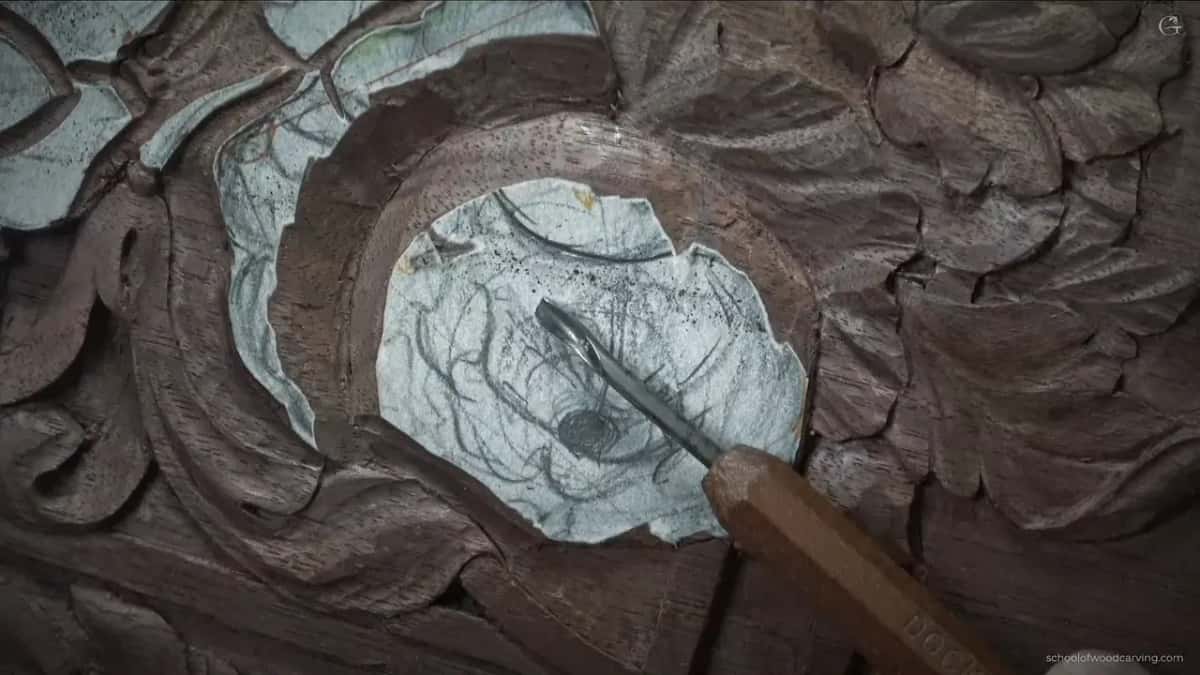 Wood handled gouge resting on white paper.