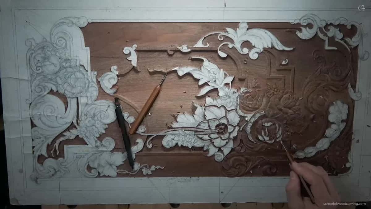 Whole panel seen from directly above with two tools lying on the surface and a hand at the lower right corner.