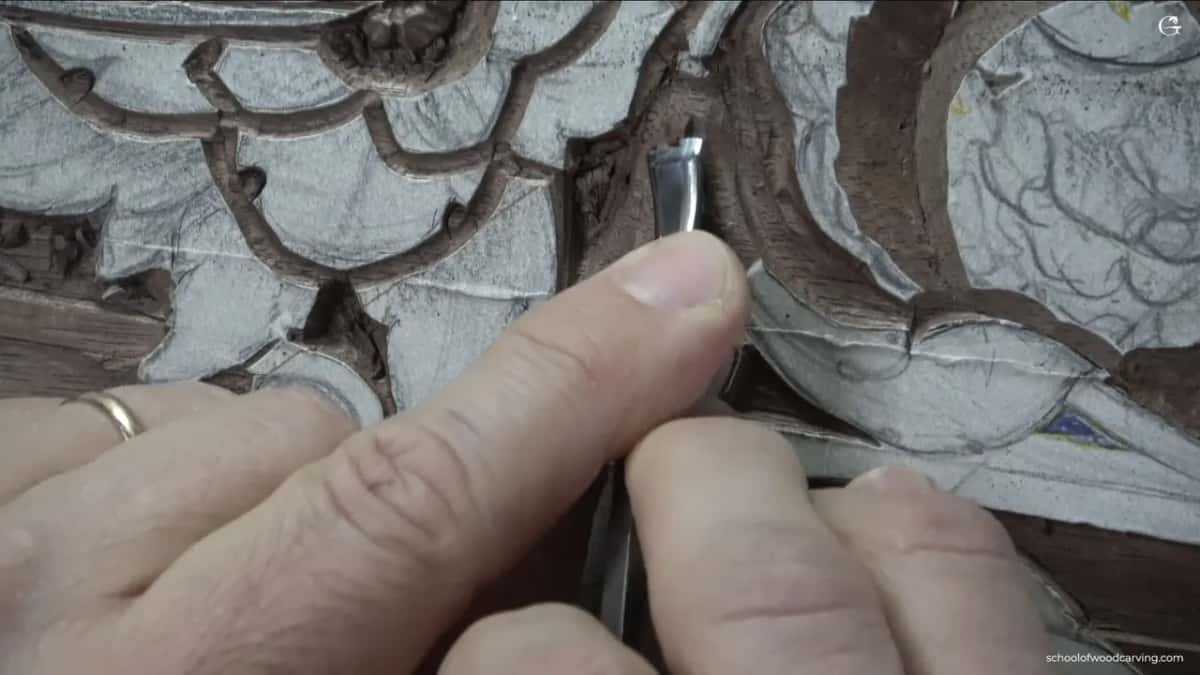 His hand fills most of the frame, and the blade underneath is barely visible.