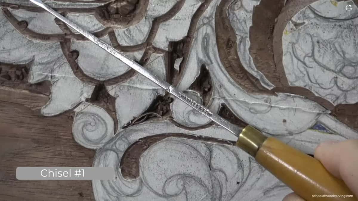 Long chisel with a brass ferrule laid right across the carving.