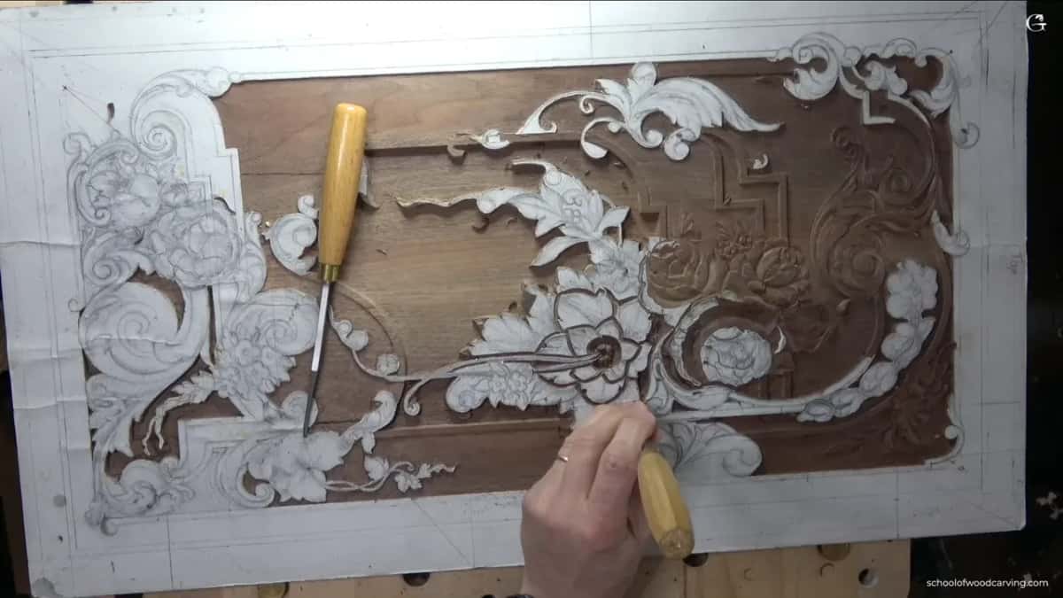 Pale handled gouge lying across the carved scroll.
