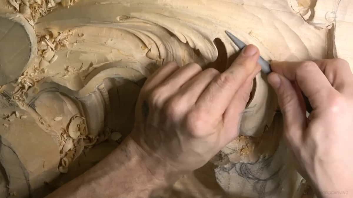 Fingertips steer a slim rasp into a leaf hollow.