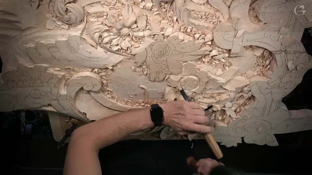 Whole panel from overhead, one hand working a tool low on the board