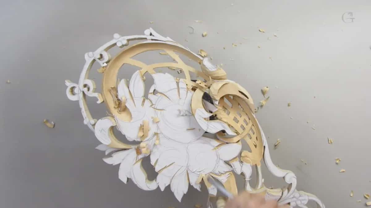 Pierced panel early in the session, paper pattern still on every surface not yet carved