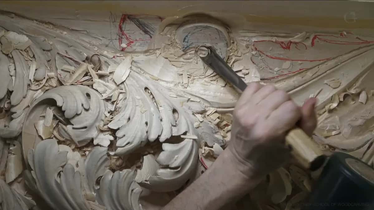 One gouge stands straight up in a round hole, and a mallet sits at the lower right.
