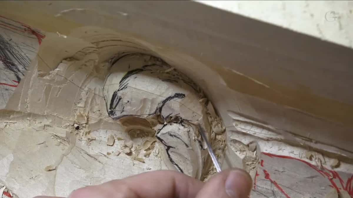 Fingers guide a very thin tool into one corner.
