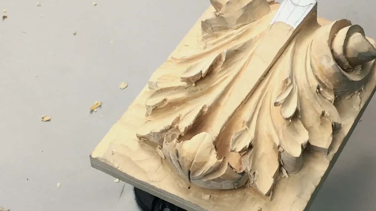 Board tilted alone on the table, nobody touching it, the undercuts already deep enough to hold shade