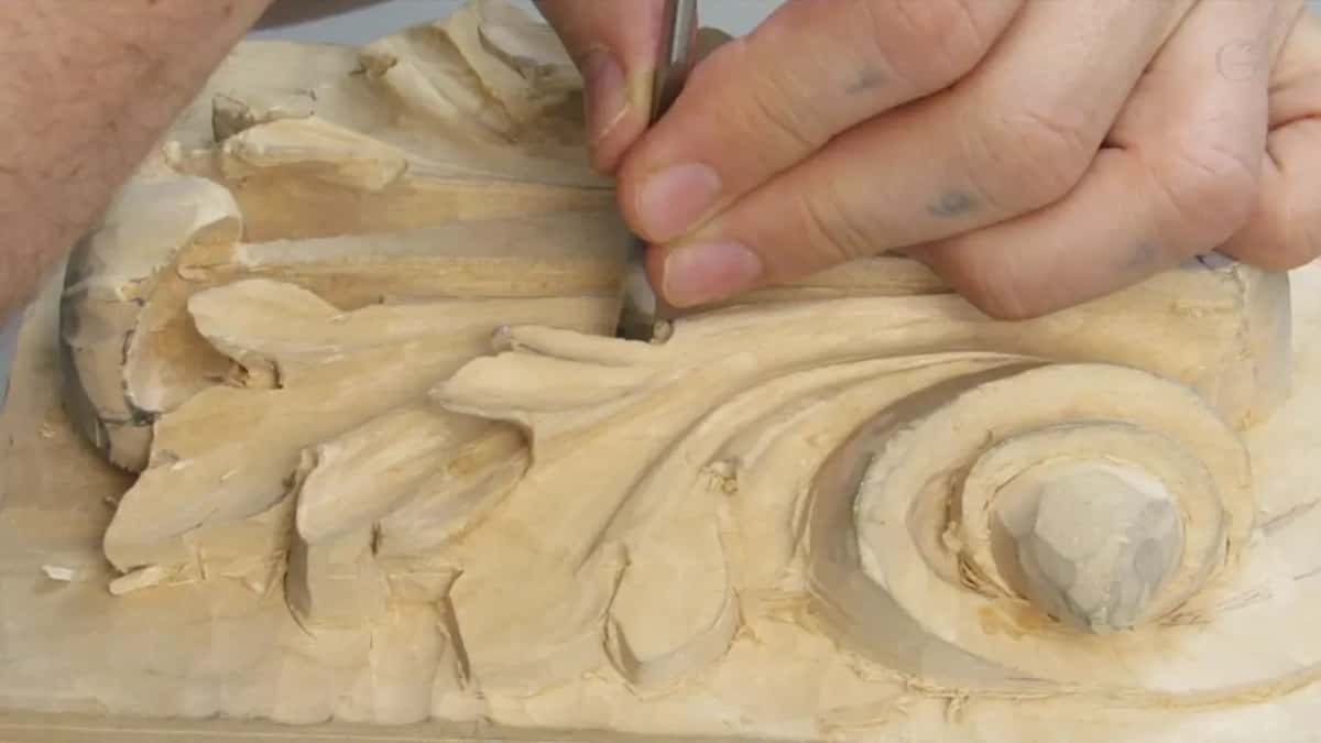 Vertical stop cut going in before any waste comes out, both hands low on the board
