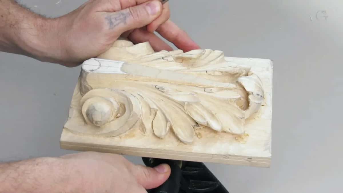 Vertical stop cut going in on the pencil mark, both hands working at the head of the leaf