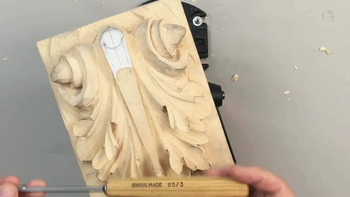 Stamped SWISS MADE 25 over 3 along the handle, lying across the finished carving