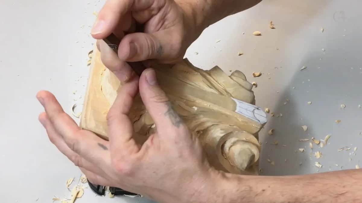 Board turned on its edge and held against the body while fingers walk a small gouge the full length of a pipe