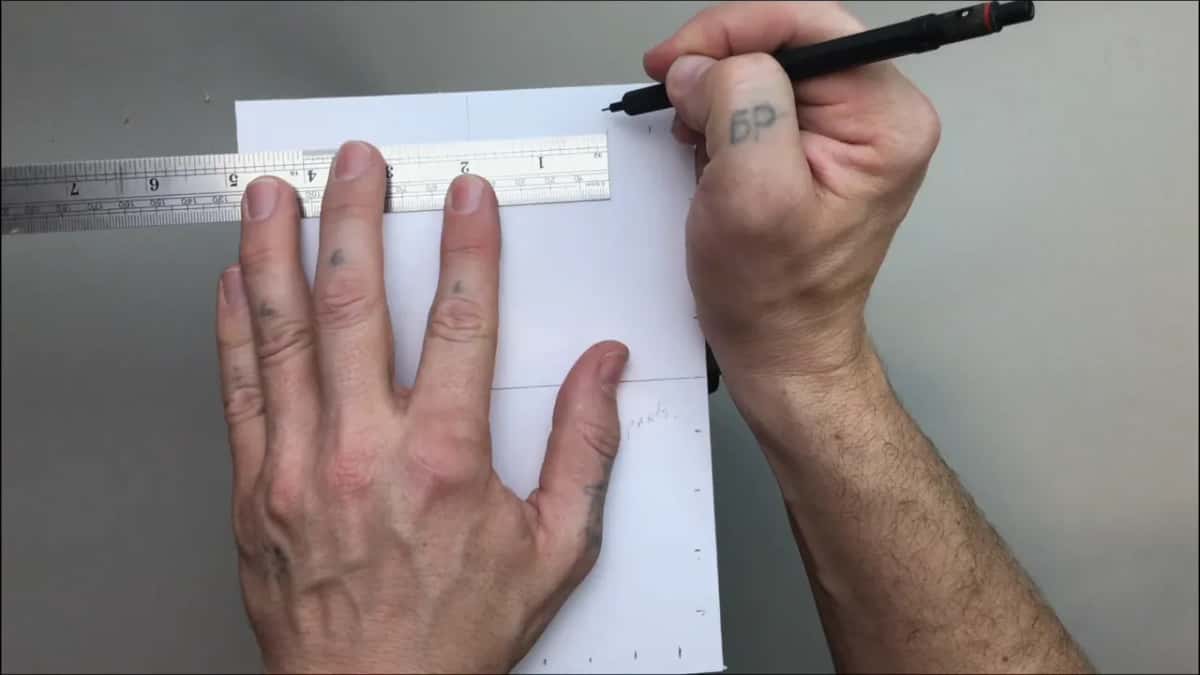 Pen marking ten divisions straight off the rule, one after another along the top