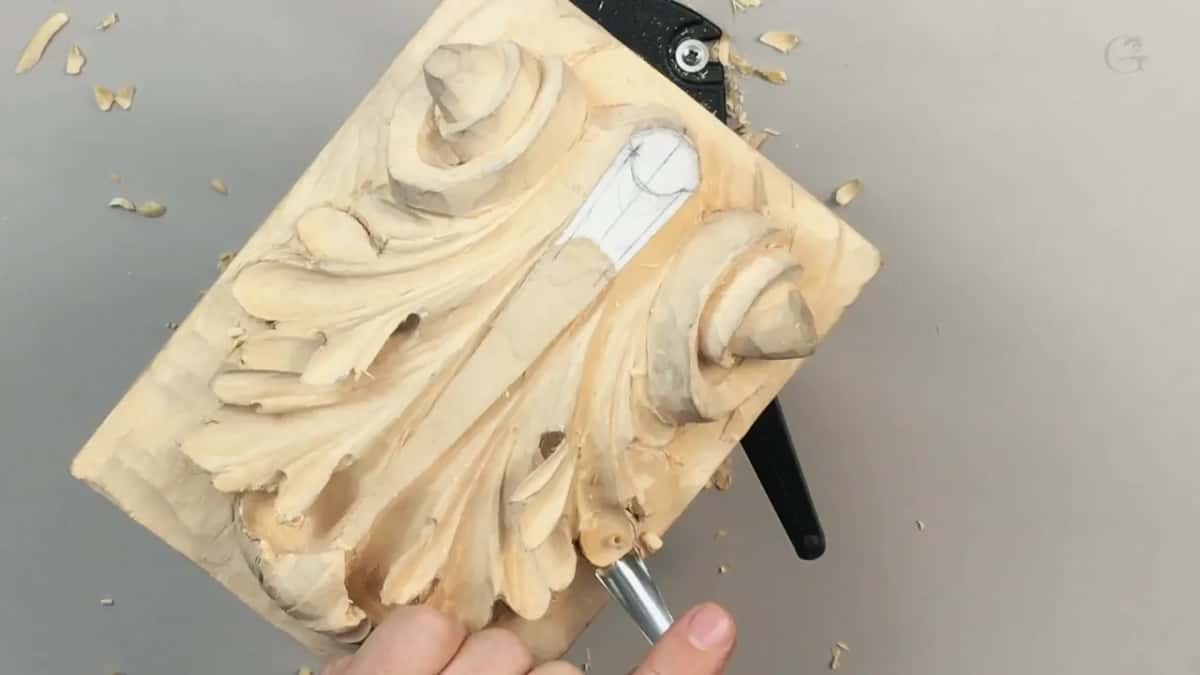 Board lying flat and a pale ash handle coming across it from the right, shavings well scattered