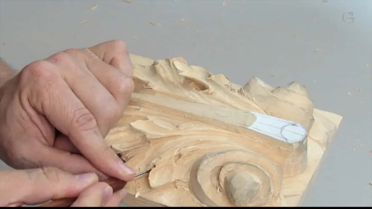 Reaching in across the carving, marker showing near the far corner