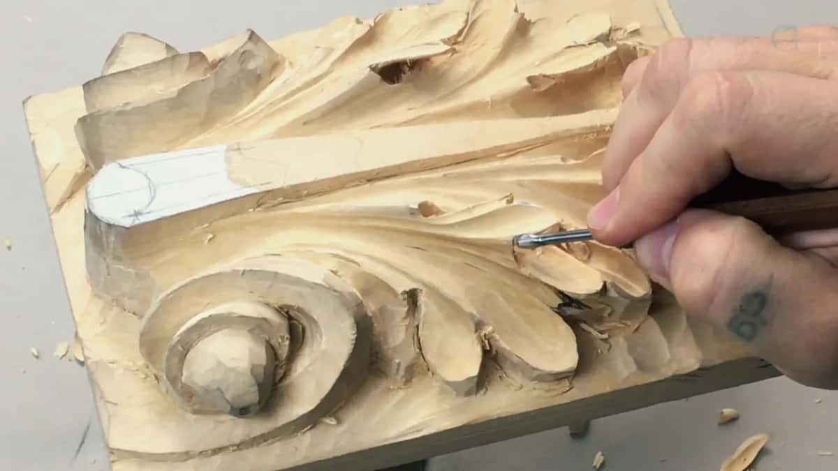 Tattooed hand, tool at the far right