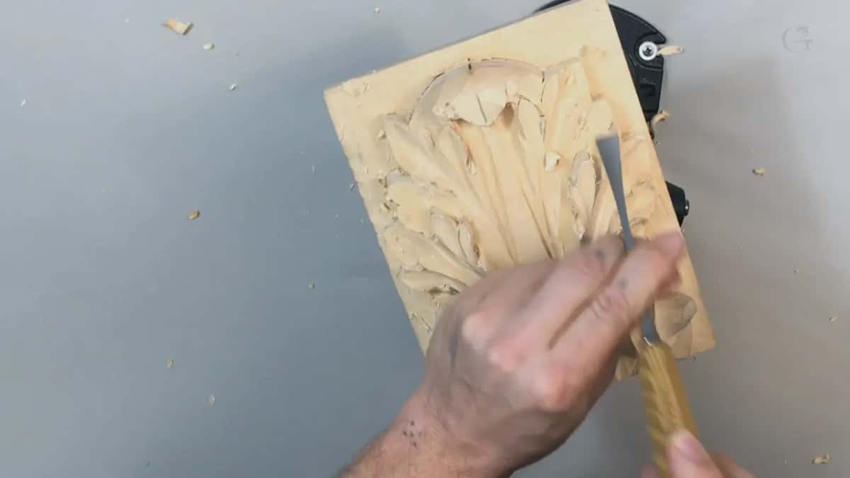 Pale handled gouge laid along the right edge