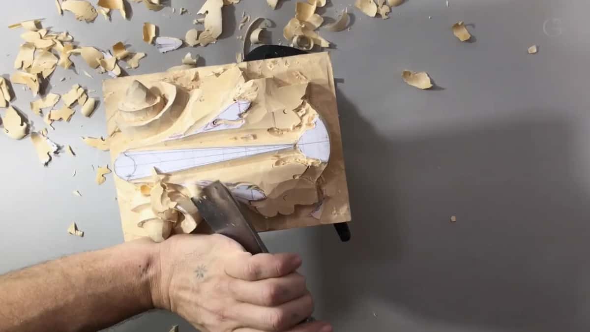 Sideways panel, a fist on a wide gouge low at its edge