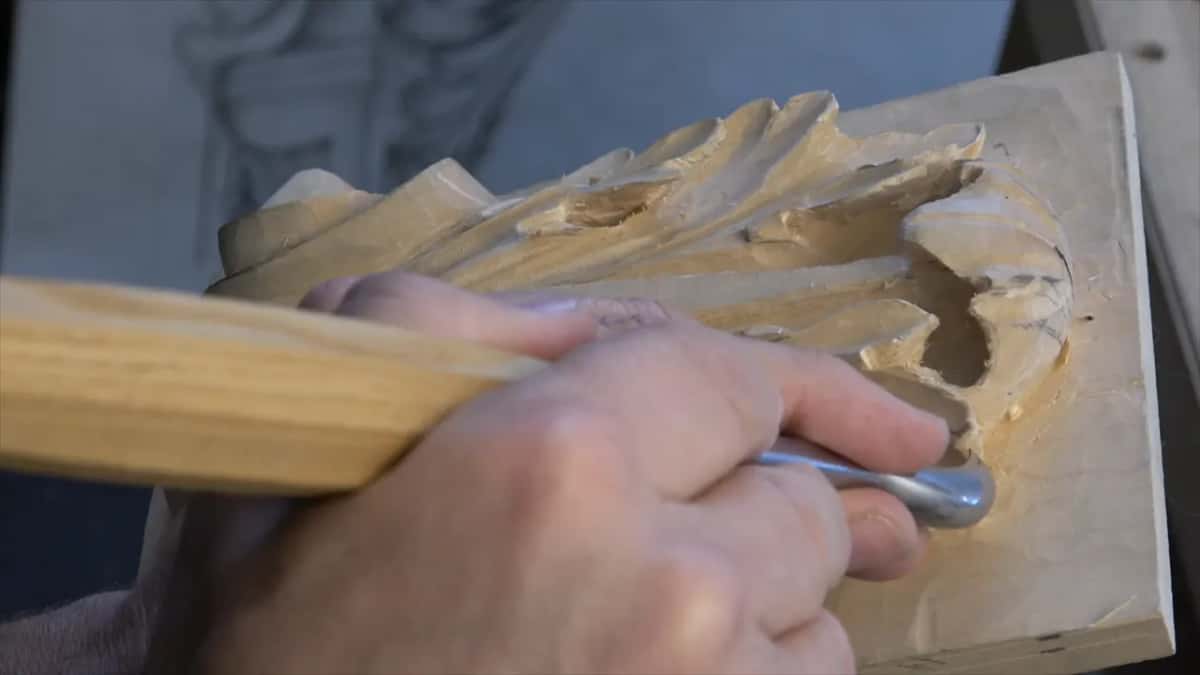 Pale beech handle gripped hard, the steel buried