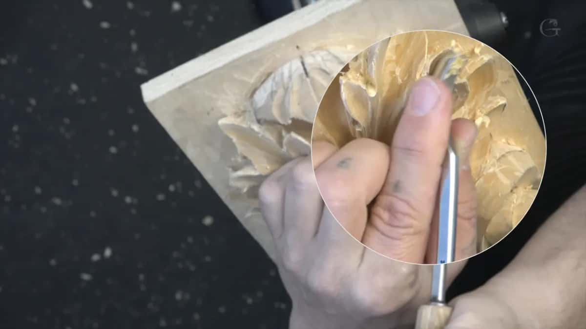 A circle magnifier on screen enlarges the hand and the blade it holds