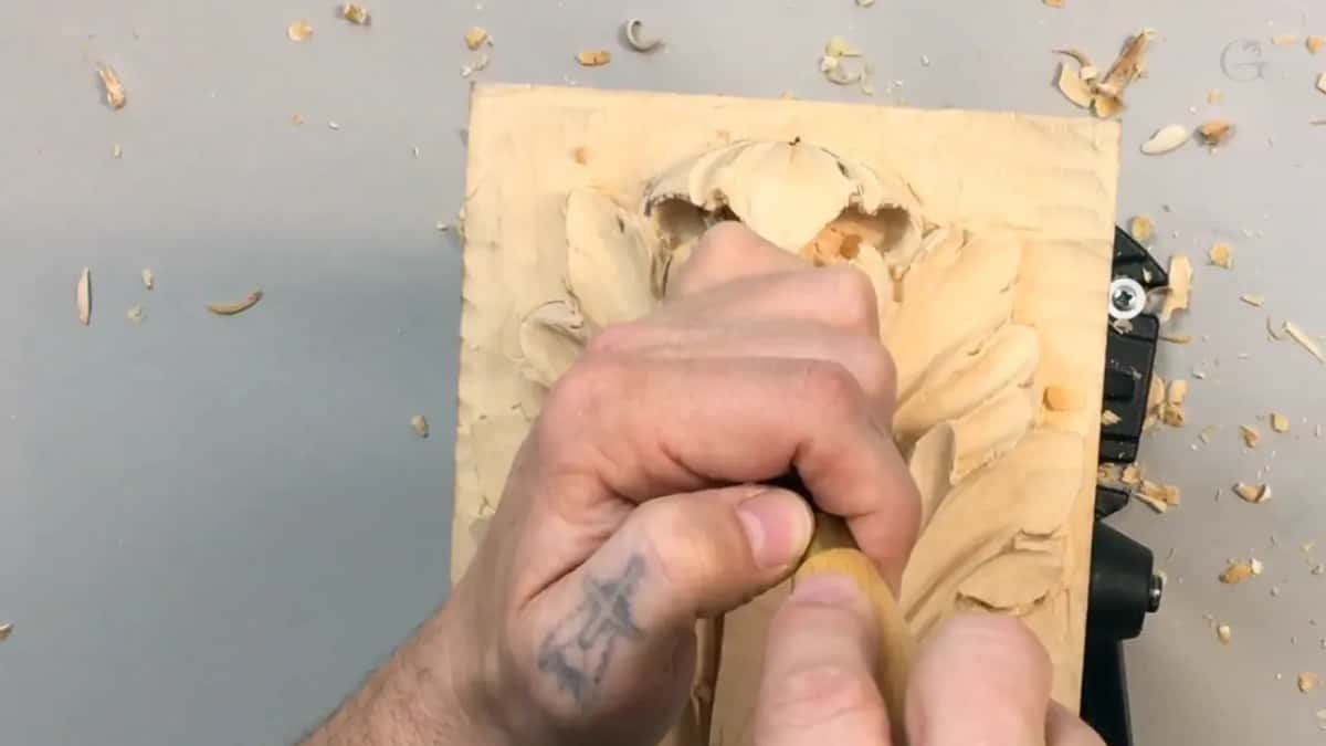 One fist dead centre on the panel, shavings scattered wide across the grey table