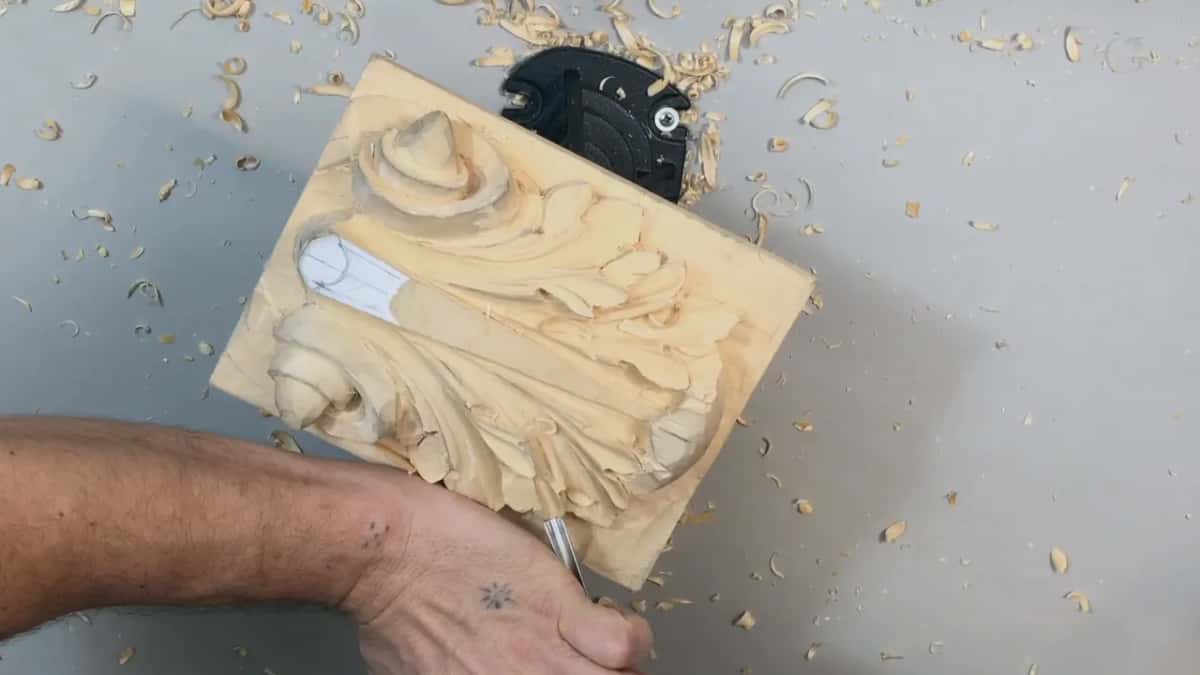 Forearm across the lower panel, the hand at work on the right