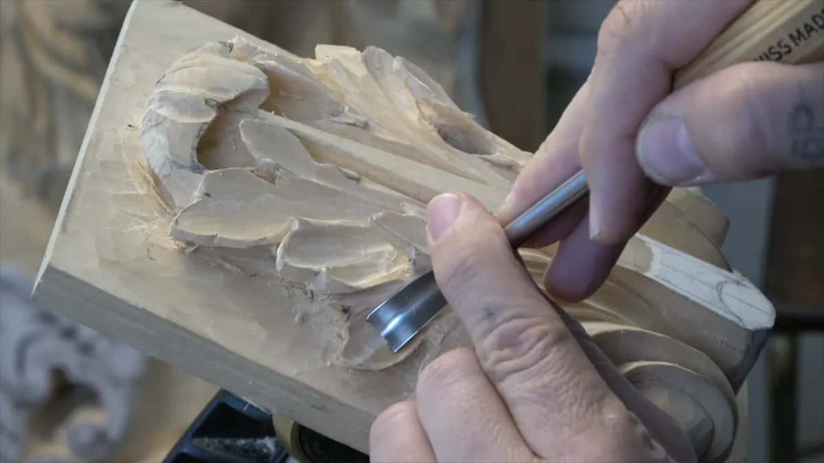 Spoon bent blade at work with a plaster cast standing blurred in the background