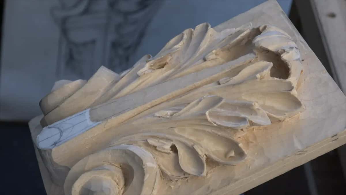 Dark leather laid across the carving