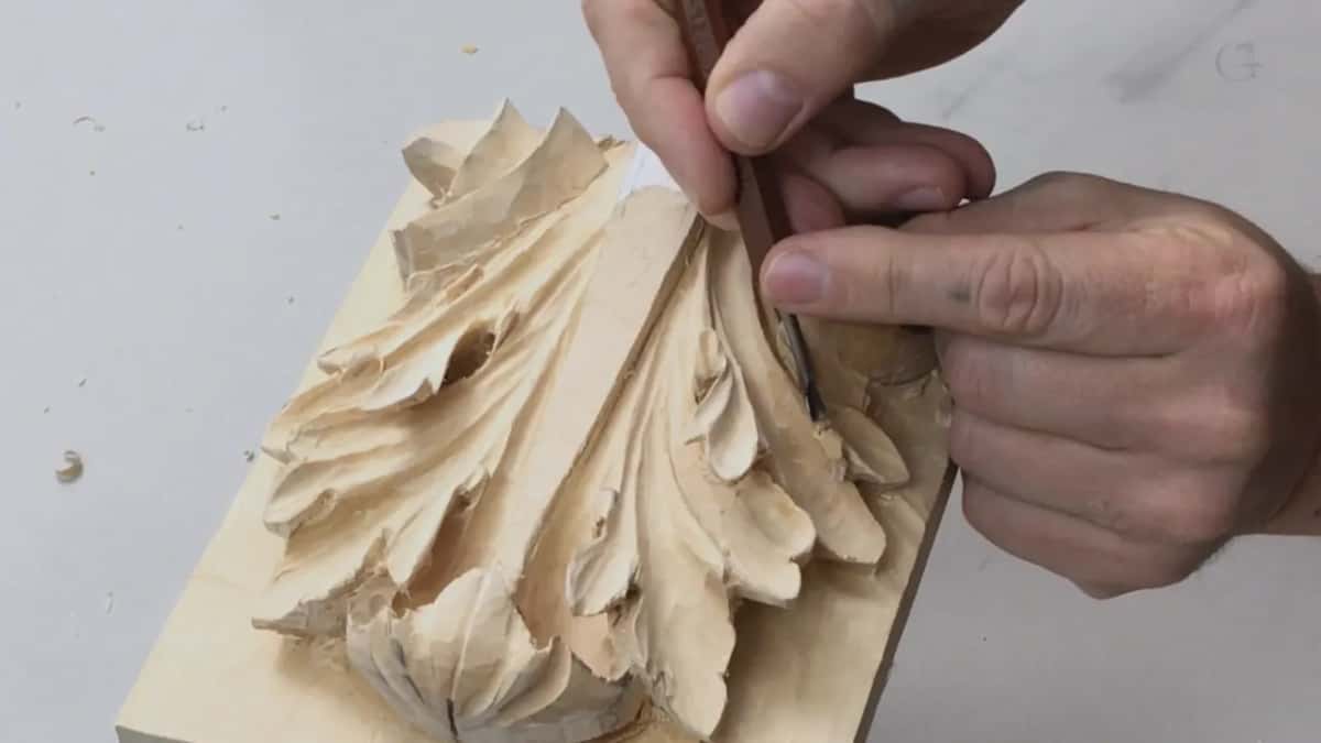 Fingers pinching at the top edge