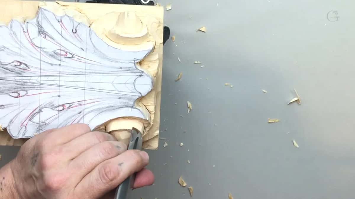 Knuckles down by the board edge, a blade turned into the volute