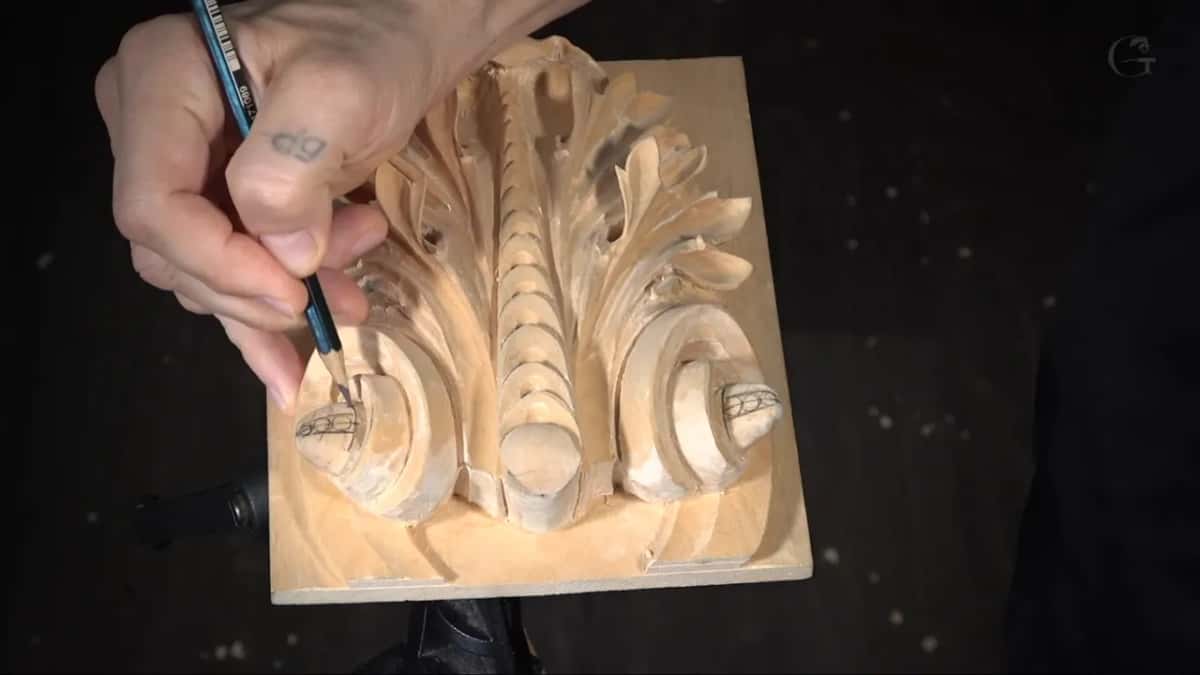 Pencil laying out the three round beads that cross a quarter inch on each of the volutes