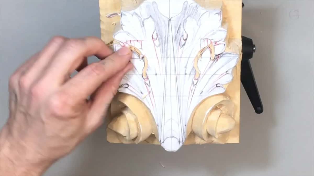 Fingertips pinching a tiny tool at the upper left lobe, red hatching beside it