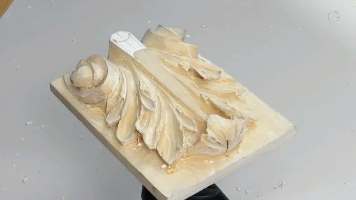 Board alone on the vise with a hook shaped tool lying on the table beside it, waiting