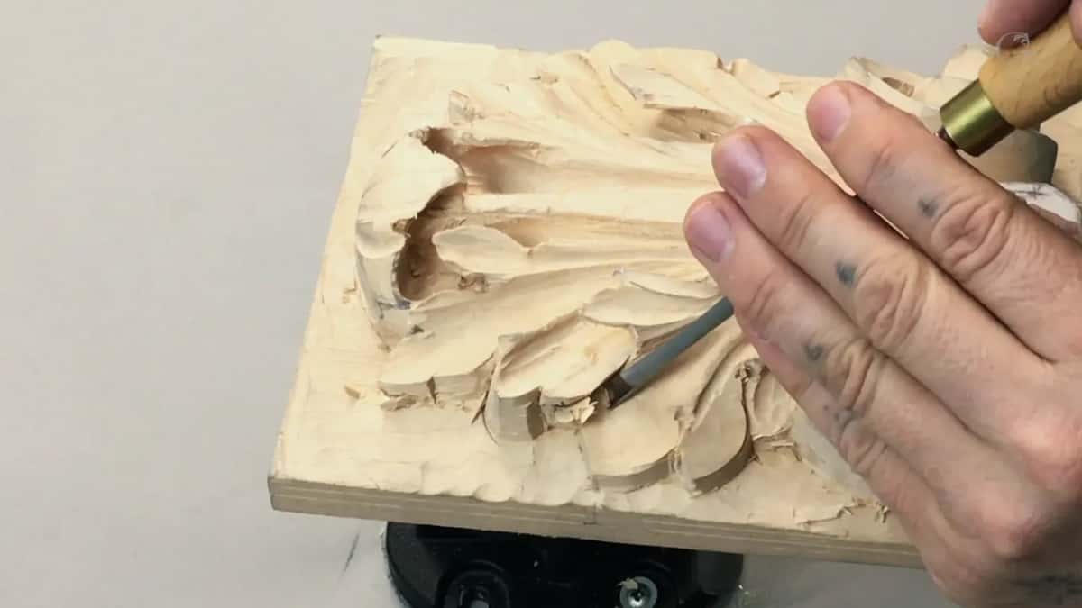 Both hands low on the board, tool inverted