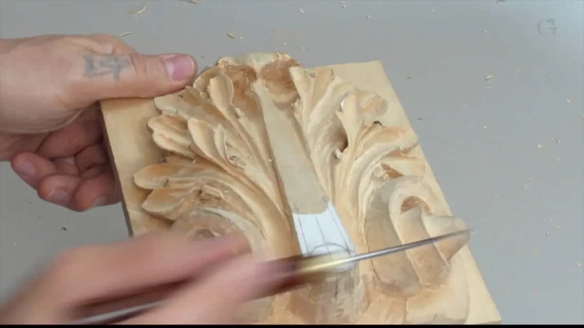 Hands over on one side with a slim tool laid flat, pale marker still running down the centre