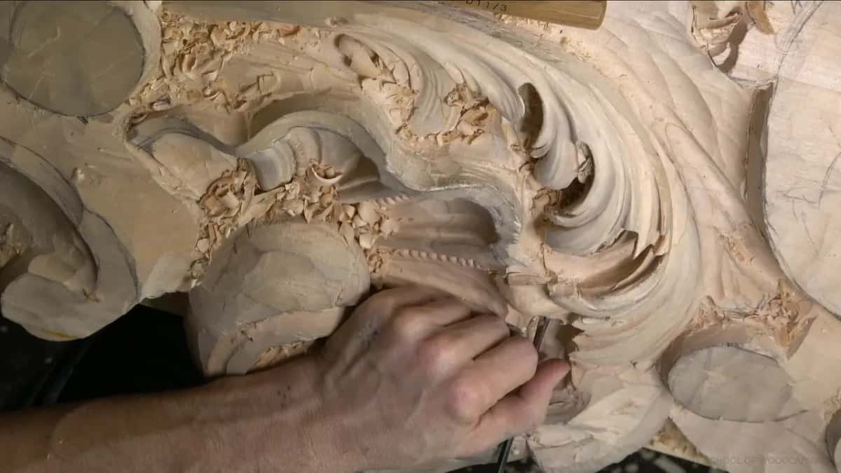 Tool beneath the lobe, beside the rough shell block kept for later.