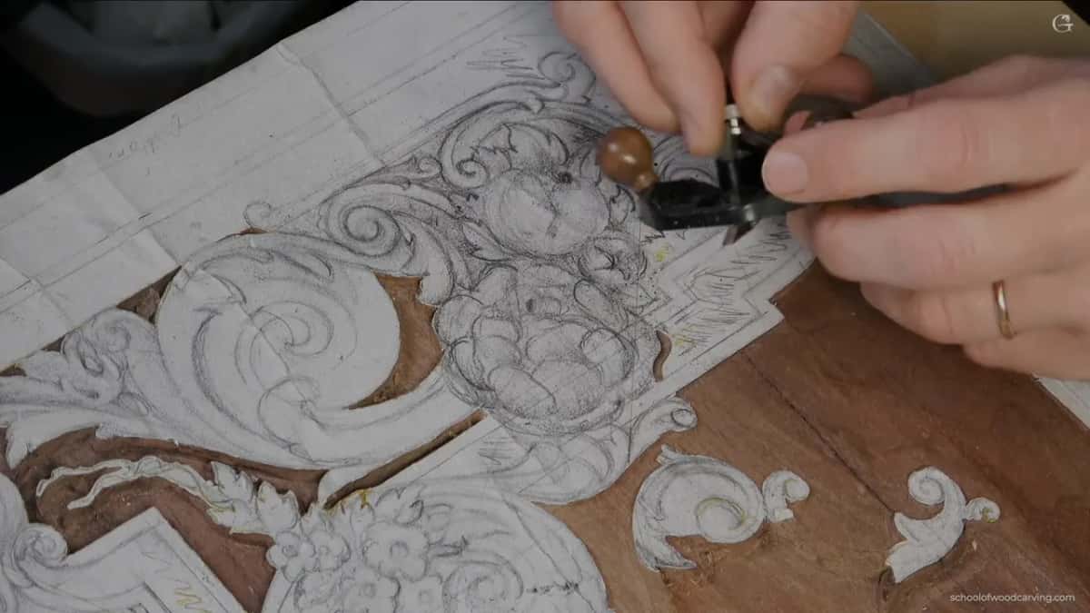 Small plane over the drawn design, held in both hands.