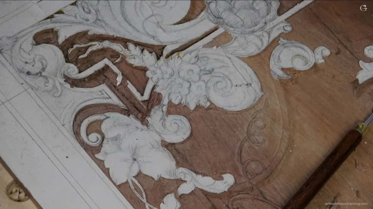 Carved flowers with a shadow line now sitting under the edge.