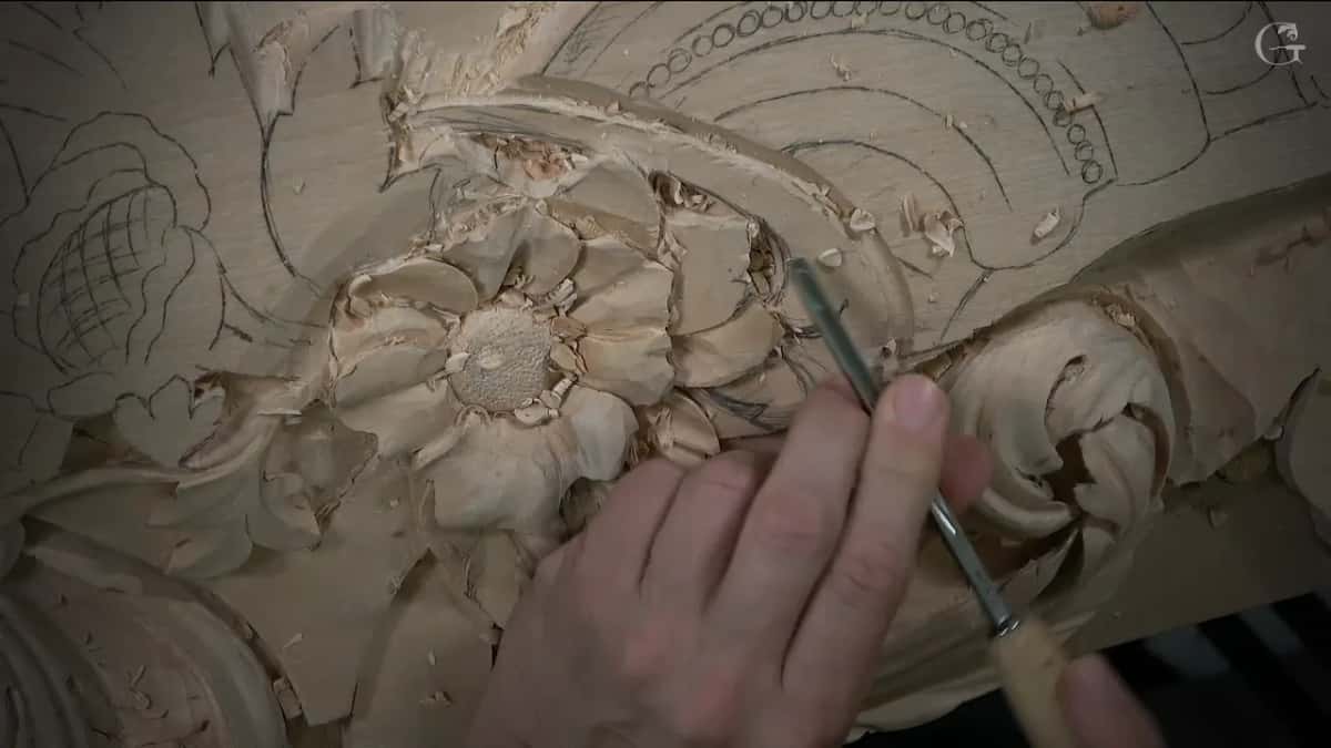 Veiner pressed into the deep gap between flower and scroll