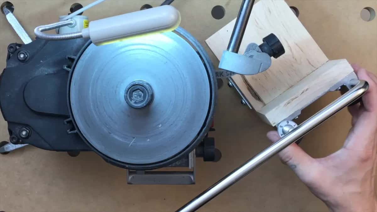 Work Sharp wheel beside a shop made hardwood block carrying the Tormek jig bar