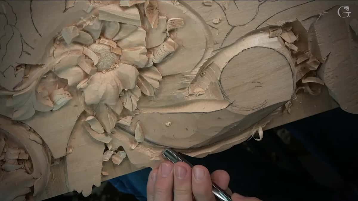 Fingertips steadying a gouge