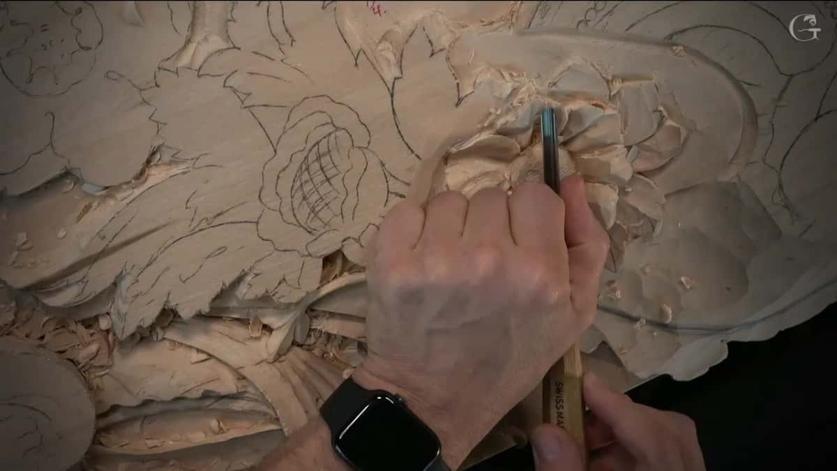 Gouge held straight down between the petals, a watch on the wrist above it
