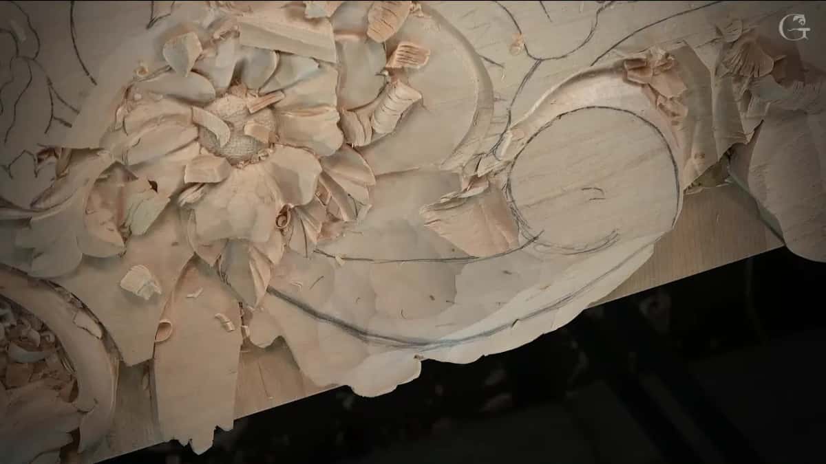 Lowered wood beside the flower, faceted by the gouge