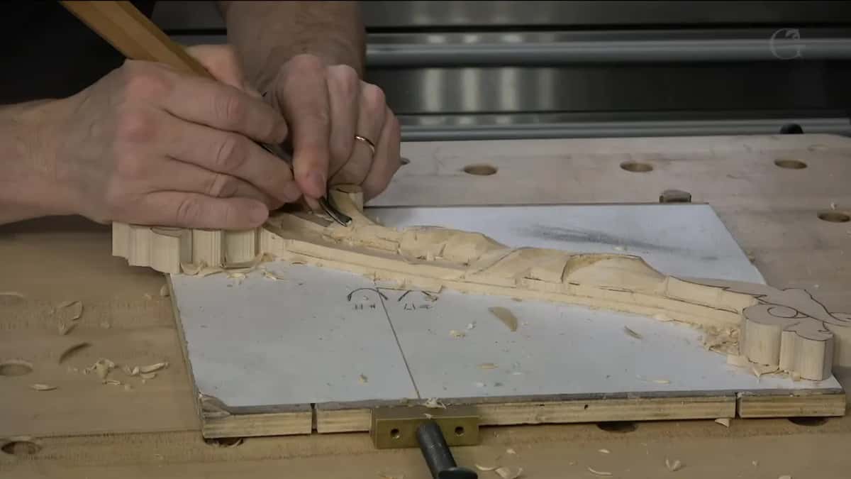 A finger laid along the blade itself.