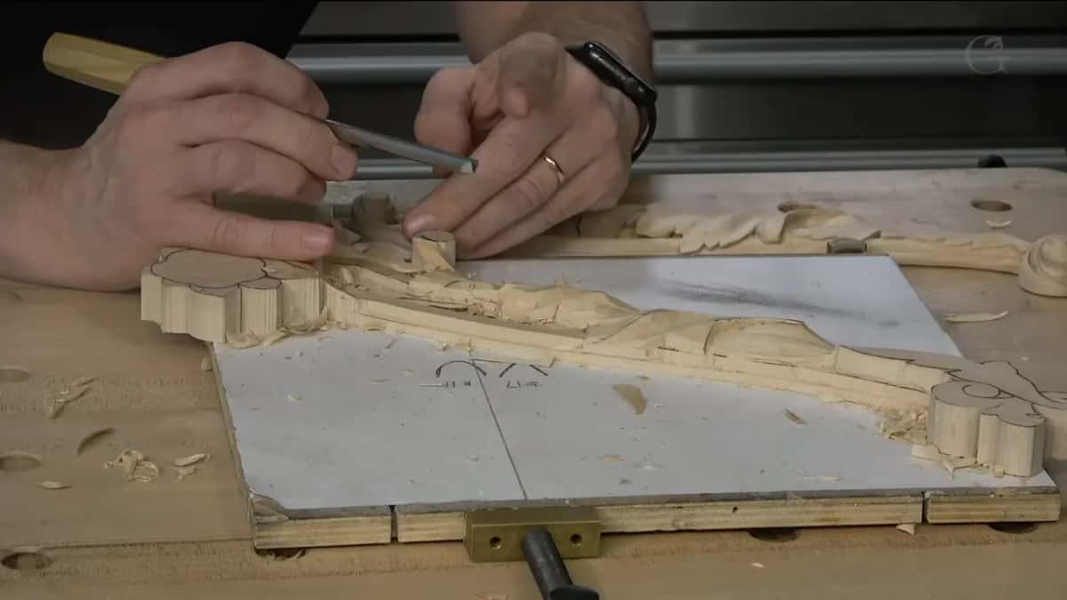 The little finger pressed against the board, doing more than it looks like it is doing.