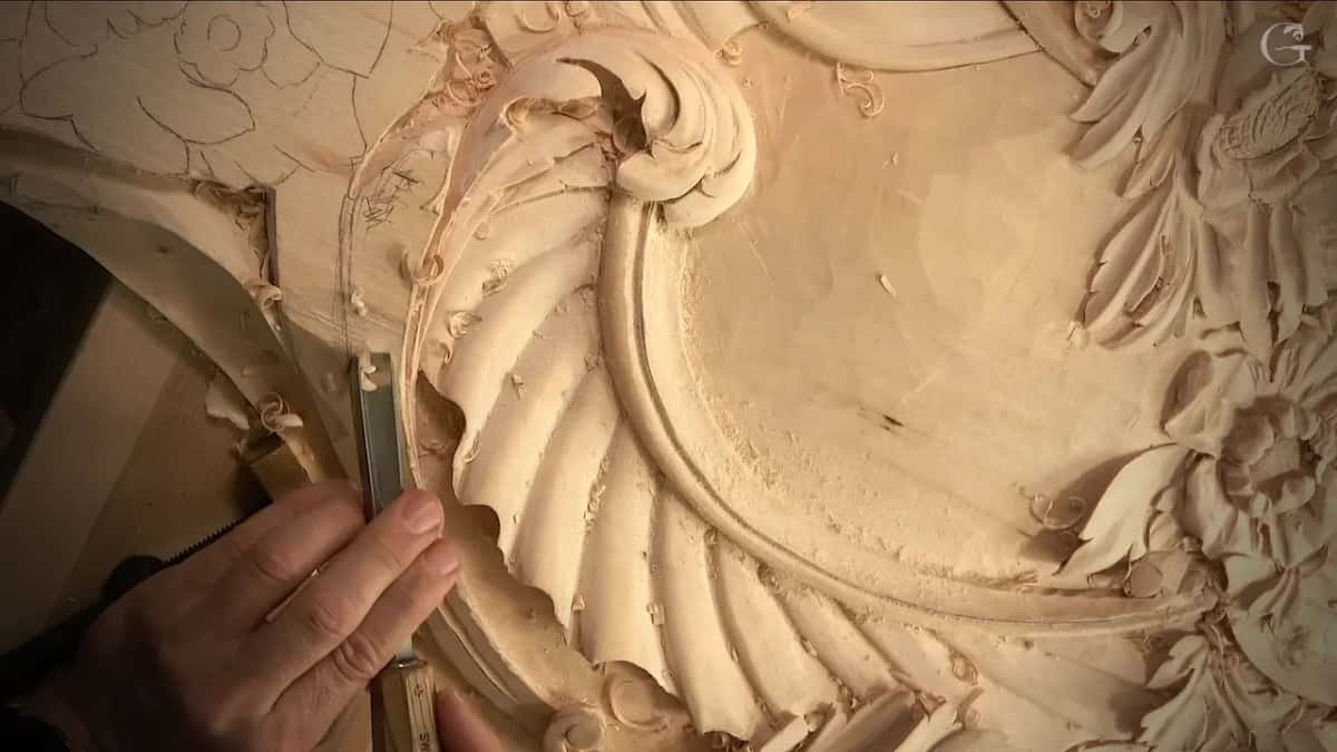 Gouge at the edge of the flutes, just below the scroll