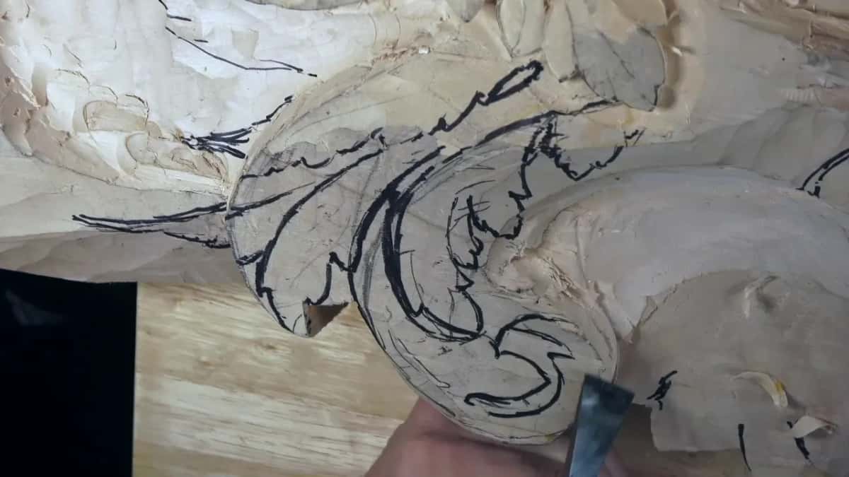 Black marker lines cover the rough block where a skew chisel starts the new head.