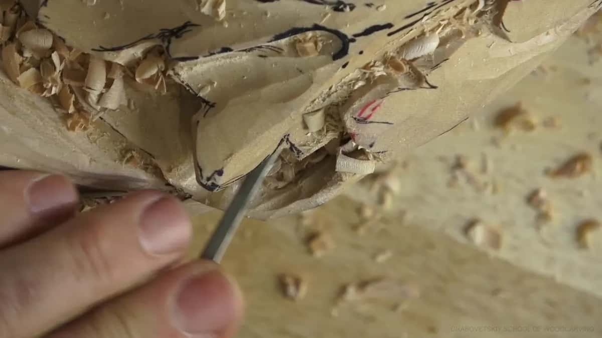 Narrow shank, deep reach Narrow round shank buried under the rim of a leaf, loose chips heaped on the ledge above and sawdust everywhere