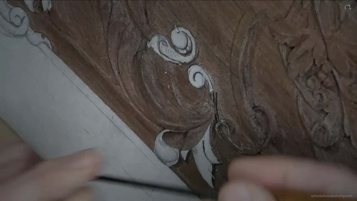 Flat blade underneath the scroll, barely a millimetre in.