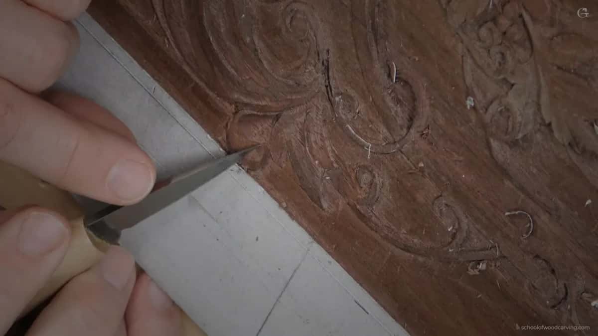 Both hands with a blade, ridges gone from the surface it just crossed.