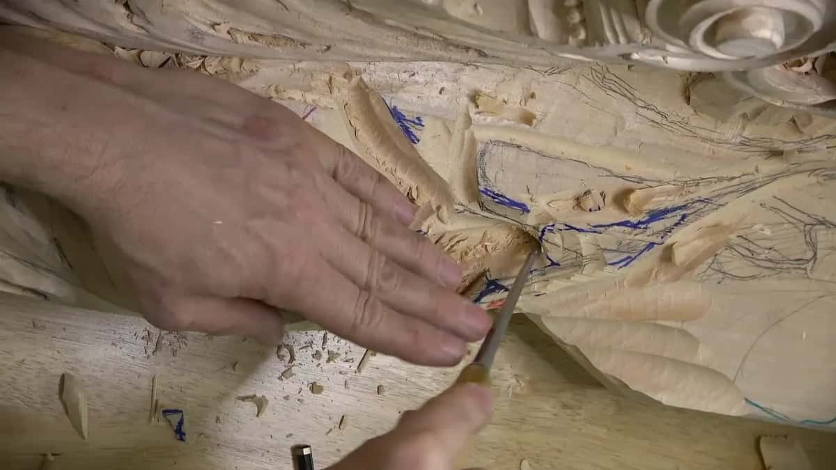 A slim tool presses into a small hole